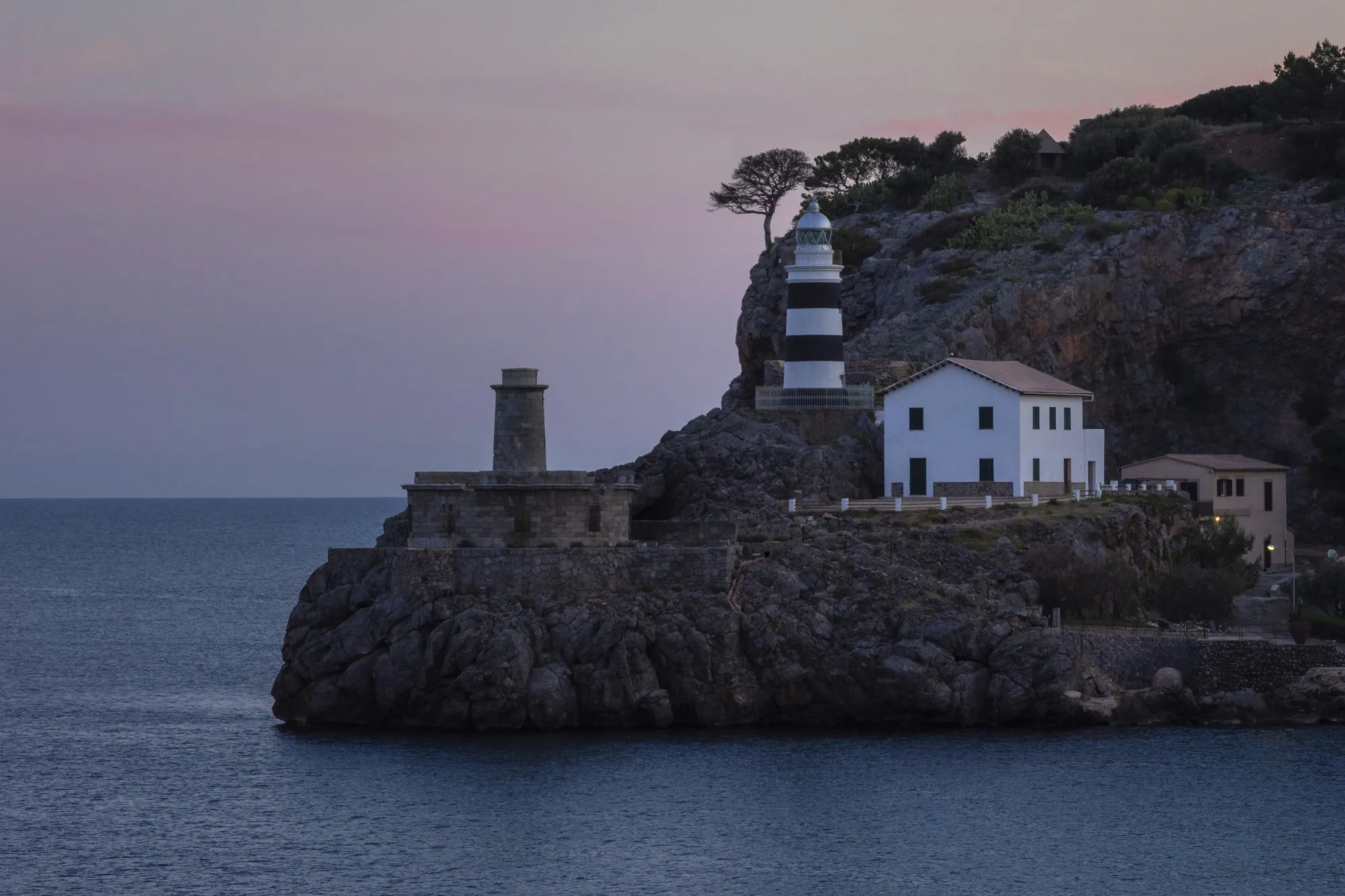 The Sa Creu lighthouse at the mouth of Port de Sóller at dusk